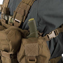 Close-up of Helikon-tex Guardian chest rig vest in brown Cordura with multiple pockets and MOLLE panel loaded with gear