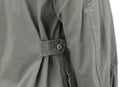 Close-up of adjustable waist tab on olive drab Mil-Tec U.S. Military style M64 Vietnam jungle BDU jacket sleeve.