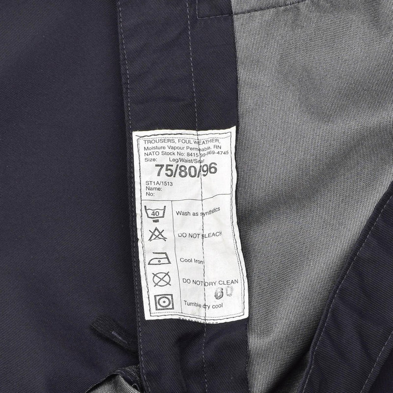 Care label inside genuine British police waterproof rain trousers for wet weather outdoor use in blue color