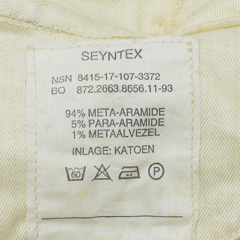 Close-up of a fabric label showing material composition and care instructions for a para-aramid cold weather mask