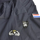 Close-up of genuine Dutch navy blue coverall with security and airborne patches and Dutch flag emblem