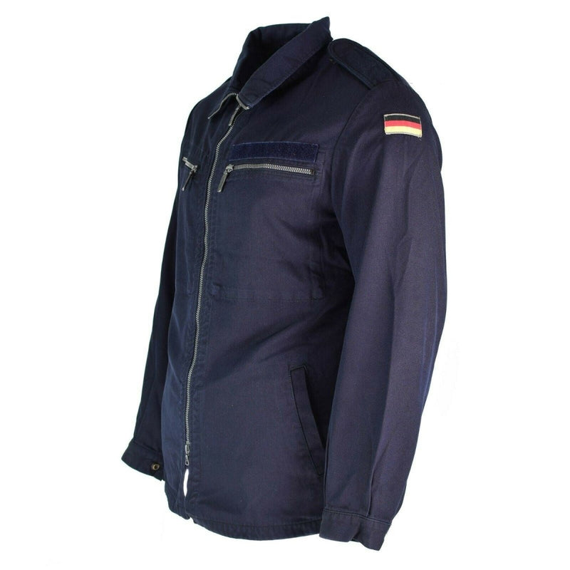 Blue German Navy jacket with fire-resistant aramid fabric, zipped pockets, and German flag patch on sleeve.