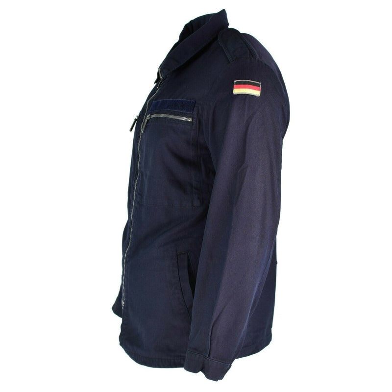 German Navy fire-resistant blue Aramid jacket with zipped pockets and German flag patch on sleeve, designed for maritime use.