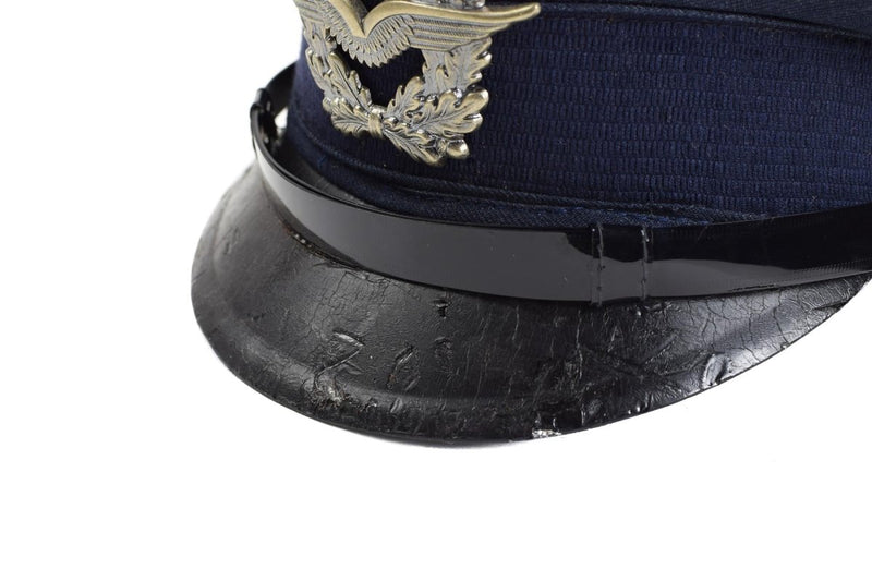 Close-up of vintage German Luftwaffe Air Forces blue peaked cap with silver insignia and black visor