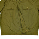 Close-up of a genuine Hungarian army shirt in olive khaki with buttoned chest pockets and durable fabric.