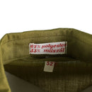 Close-up of khaki Hungarian military shirt collar showing polyester and műszál fabric label and size 52 tag.