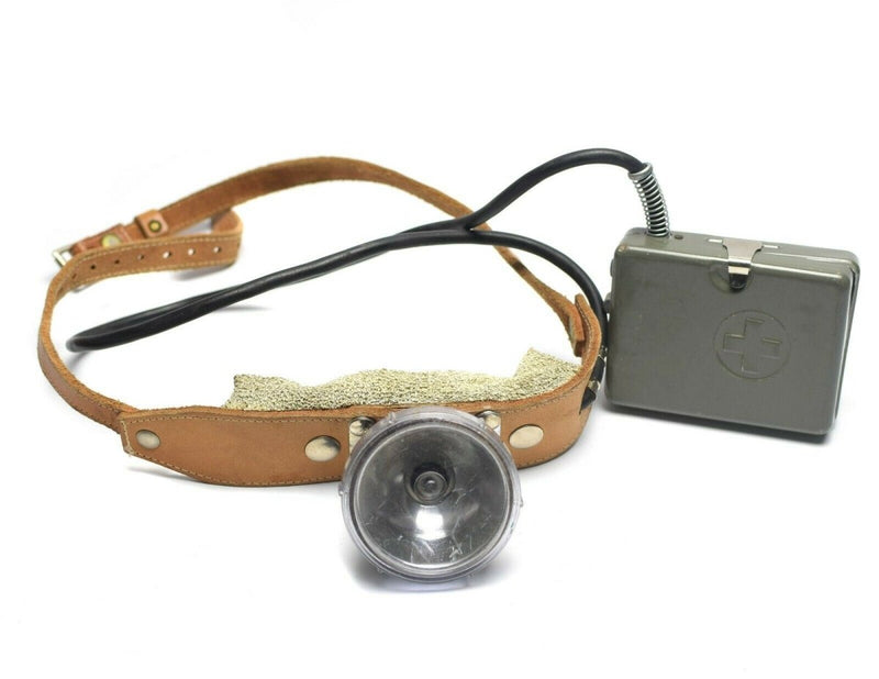 Vintage genuine Swiss Army headlamp flashlight with leather strap and metal battery pack from Swiss military Cold War era