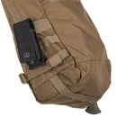 Tan Helikon-Tex Bushcraft Satchel with MOLLE straps, compression straps, and attached black tactical pouch detail.