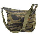 Helikon-Tex Bushcraft Satchel shoulder bag in camouflage pattern with adjustable strap and MOLLE attachment panels.