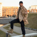 Man wearing MFH brand khaki tactical ripstop military-style shirt with black pants and boots outdoors