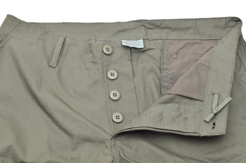 Close-up of olive green Mil-Tec ripstop cargo pants with button fly and reinforced stitching.