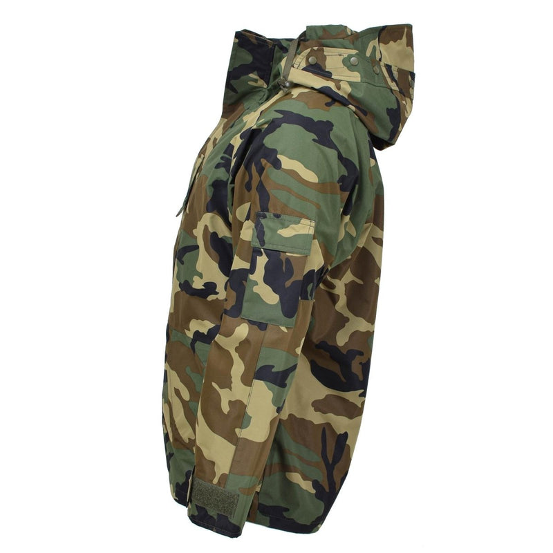 MIL-TEC military camo jacket with 3-layer Goretex for windproof, waterproof protection in wet woodland conditions.