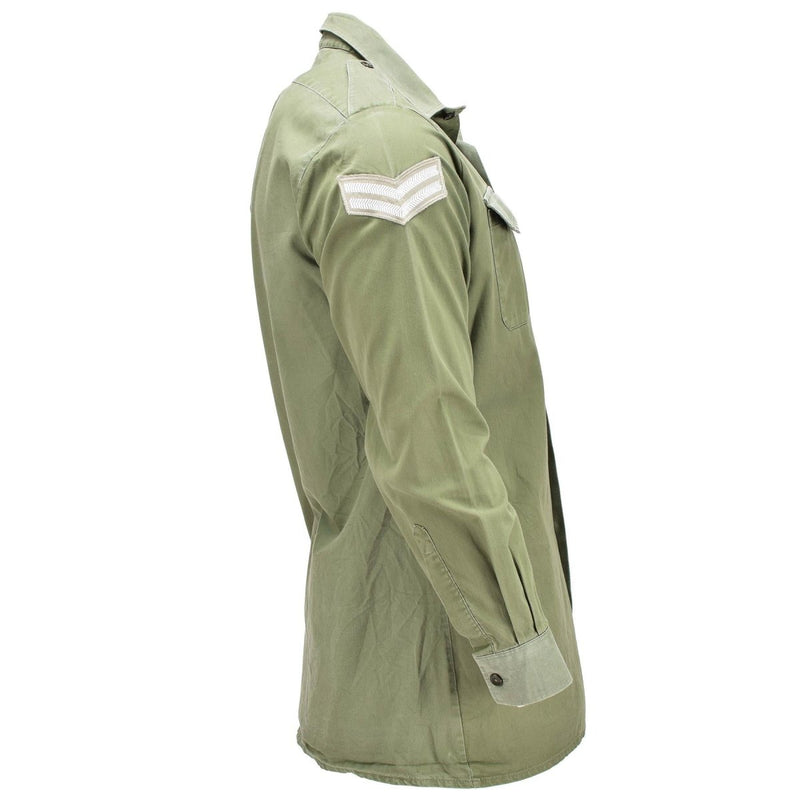 Side view of original British army olive green long sleeve military service shirt with rank insignia patch on sleeve