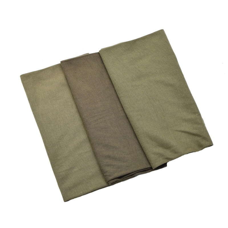Three folded green fabrics of different shades on a white background
