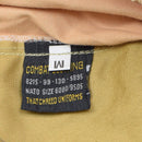 Close-up of a clothing label inside original British military safari tan work pants with size and uniform details.