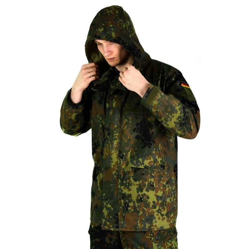 Man wearing original German army Flecktarn GoreTex waterproof rain jacket with hood and camouflage pattern