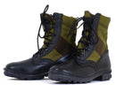 Pair of black and OD green Bates side zip military boots with laces and rugged soles on white background