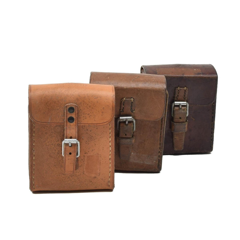 Three vintage original Swedish military hard leather belt pouches for magazines in varying shades of brown