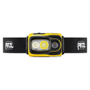 Yellow PETZL Swift RL rechargeable headlamp with black adjustable band and high-performance LED lights.