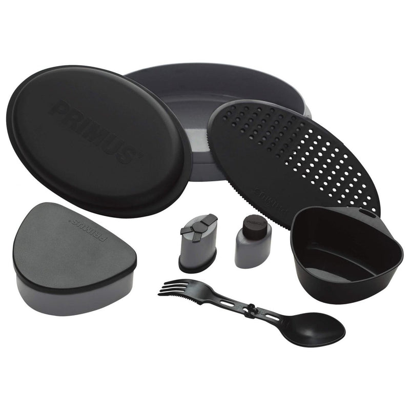 Black Primus Frigg W Piezo camping mess kit with plates, utensils, and containers for outdoor meals