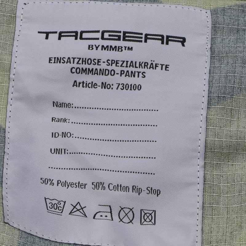 Close-up of TACGEAR Swedish Military style combat pants label showing fabric details and care instructions on splinter camo ripstop material.